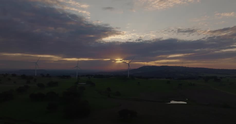 The windmills turn as the sun rises