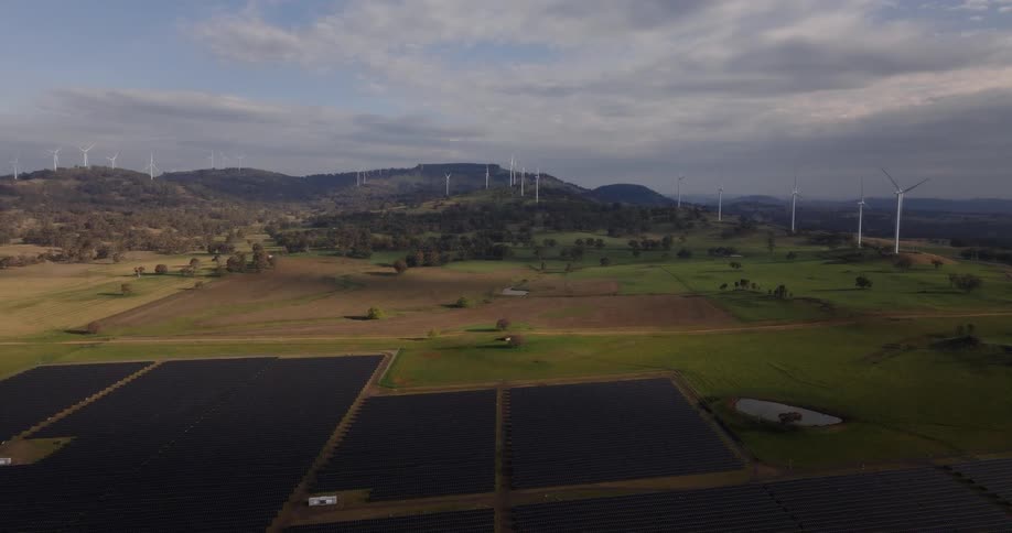 Aerial view of majestic landscape revealing a large Solar and Wind Farm