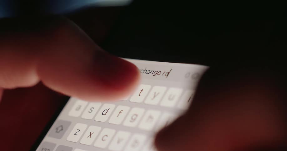 A person uses their thumbs to search a term on their cell phone