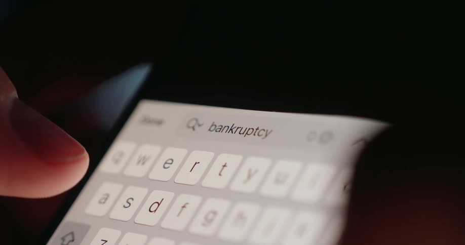 A person uses their thumbs to type out a text message