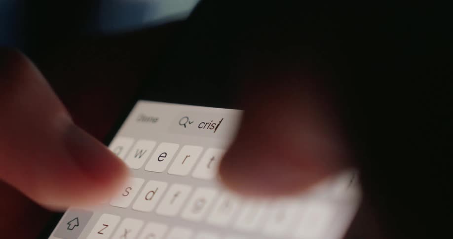A person begins typing on the screen of their cell phone