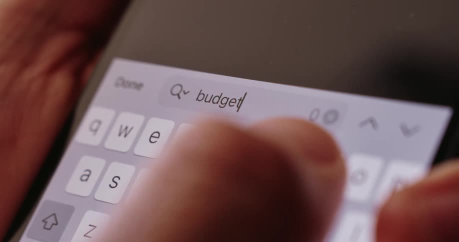 Close up of a finger typing on a smartphone screen