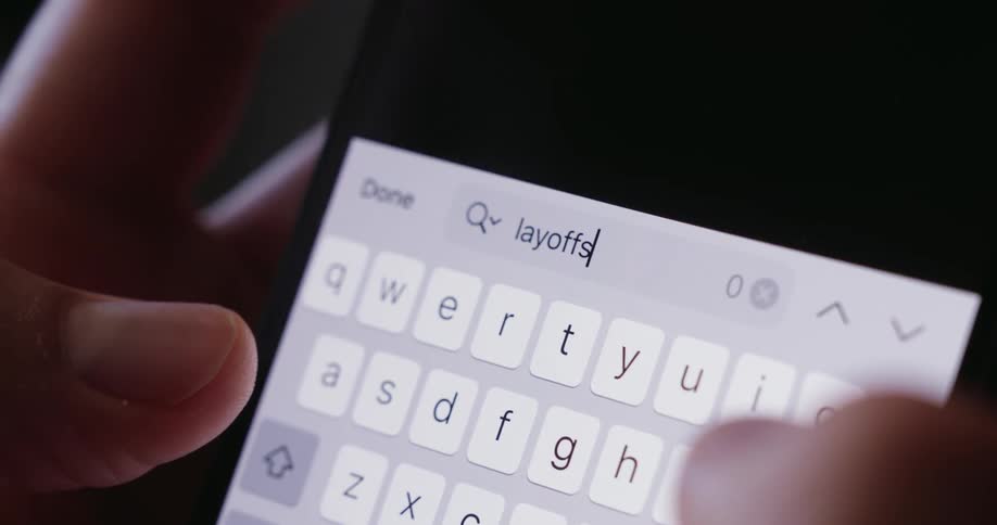 Persons fingers typing on a smartphone keyboard