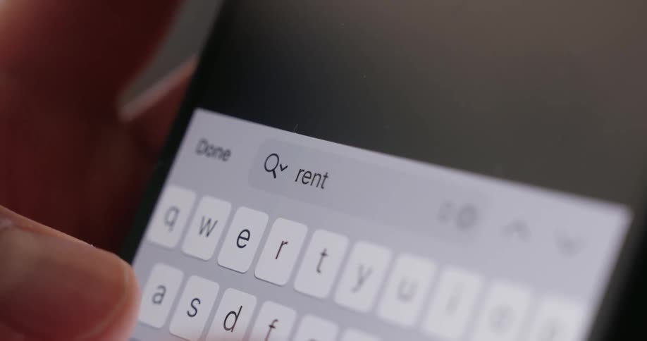 A person types the word rent into the search engine on the phone