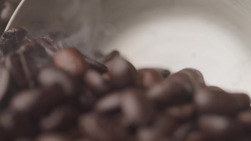 Coffee beans are poured into a scoop
