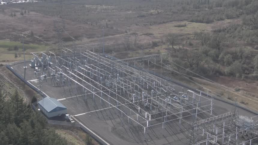 Aerial view of an industrial electrical substation in a rural setting