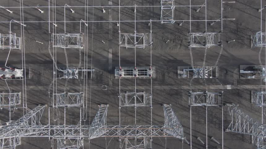 A power station filled with multiple transmission lines and interconnected cables