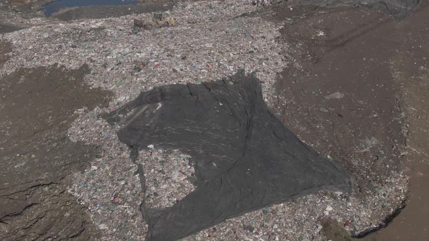 Aerial view of an openair landfill with a river around it