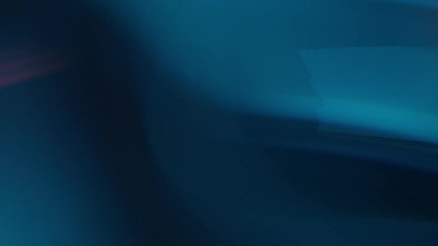 Red and blue lights shine onto a man driving a vehicle