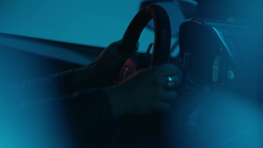 Pair of hands on the steering wheel of a lamborghini