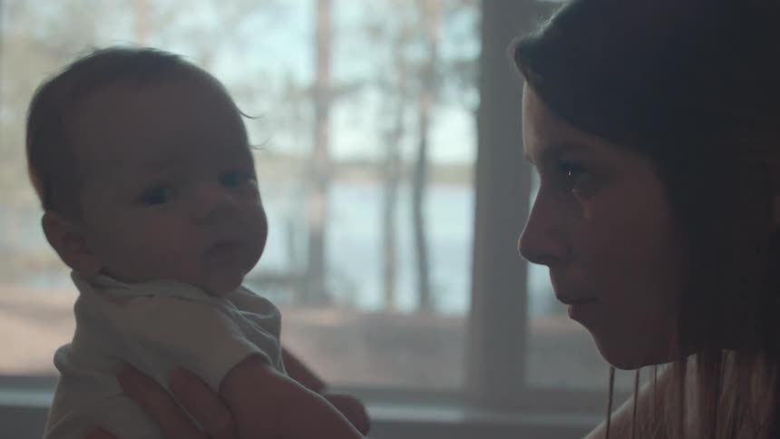 Mother sitting interacting with her baby