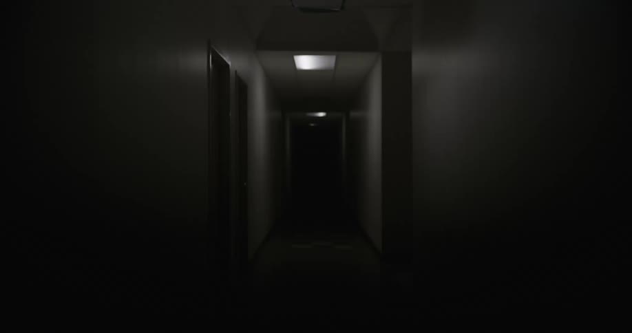 A dark lobby passage lined with a series of rooms where flickering lights intermittently illuminate the space alternating between brief brightness and near darkness every few seconds