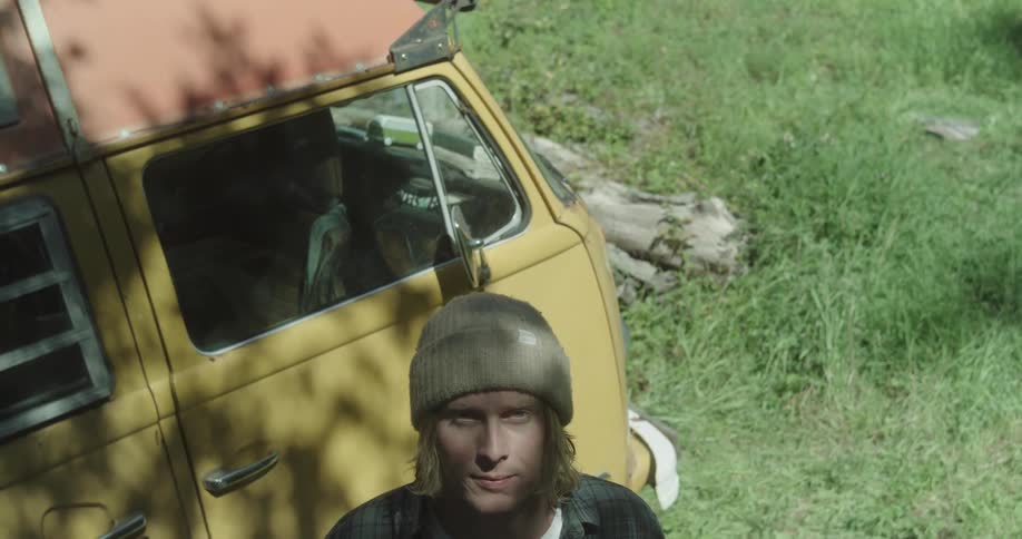 A man looks up by the van