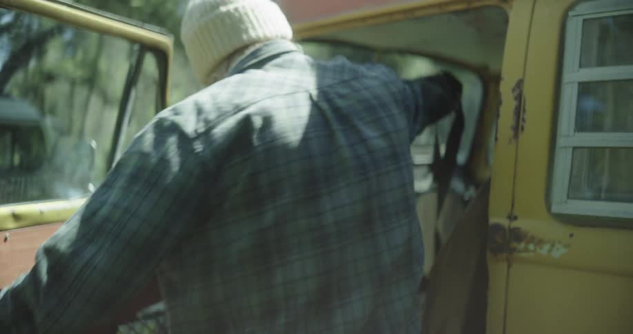 A man gets into his van in the forest