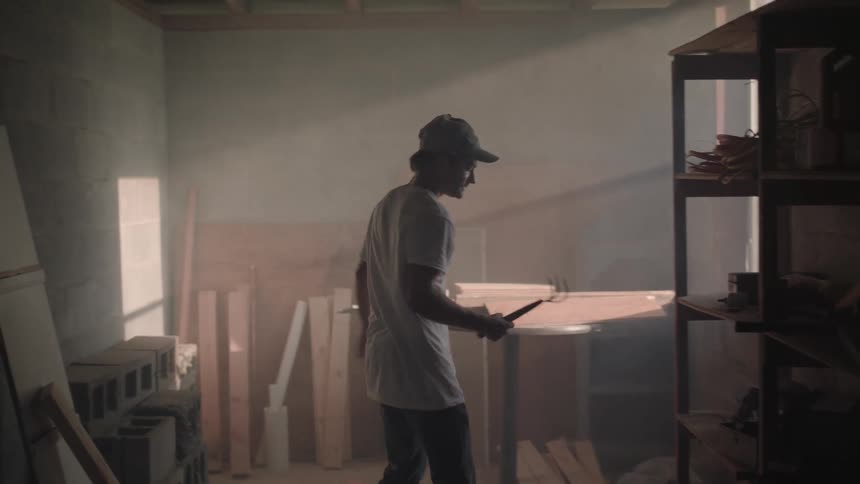 A man takes a tool from a shelf