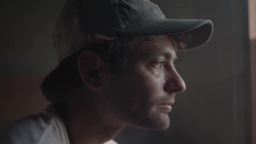 Portrait of a bearded man with a cap looking straight ahead