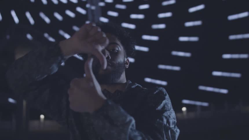 Portrait of a man dancing and making hand movements