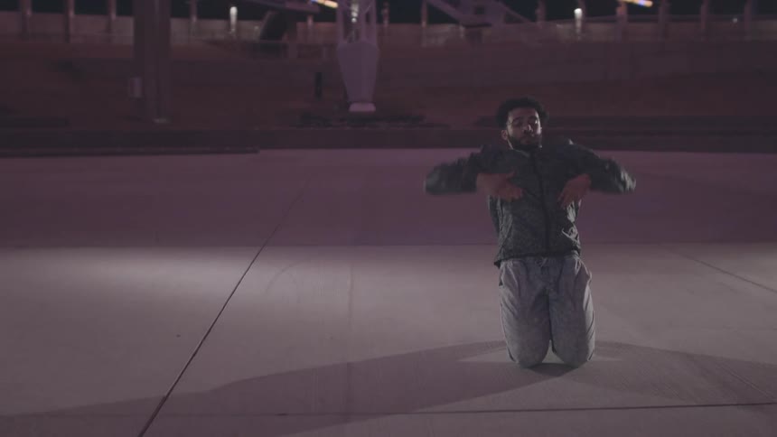 A man is break dancing at night