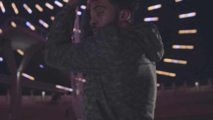 Man dancing in an indoor environment with abstract lights