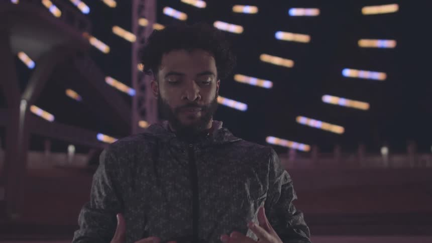 A man is dancing in front of the building