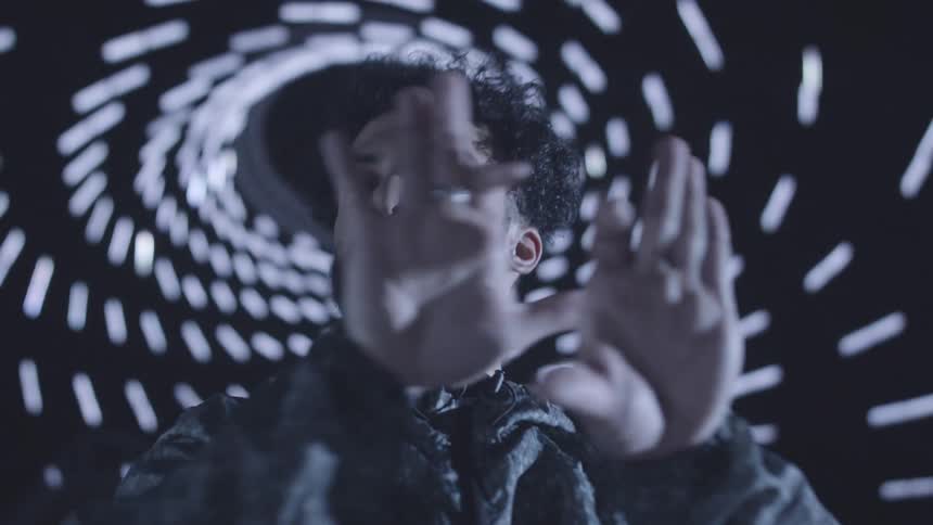 A man is waving his hands and dancing