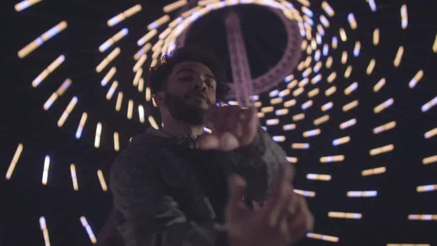 A man dances under lights