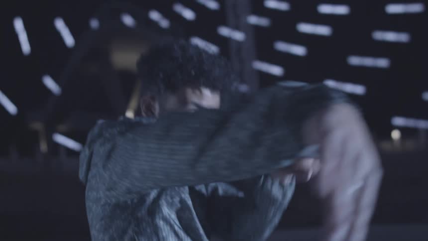 A man walks and starts dancing