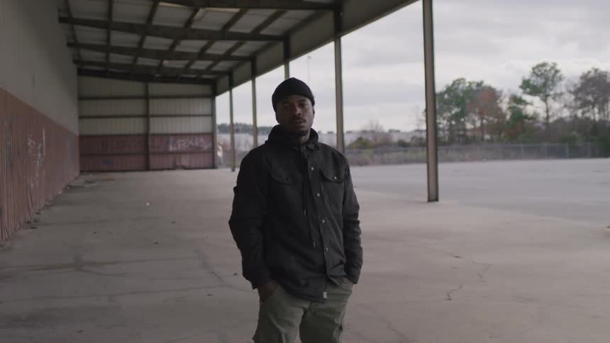 A man stands outside a building