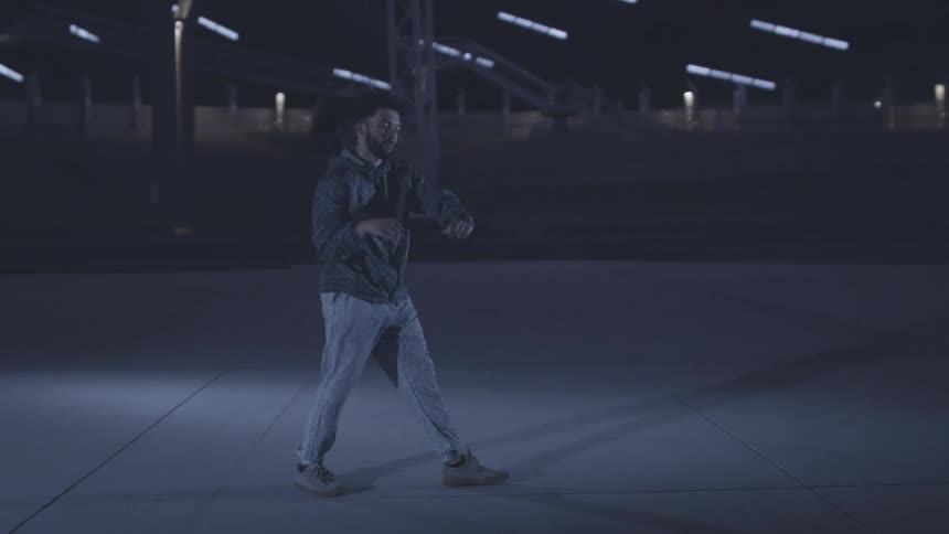 A man is dancing by the steps outside
