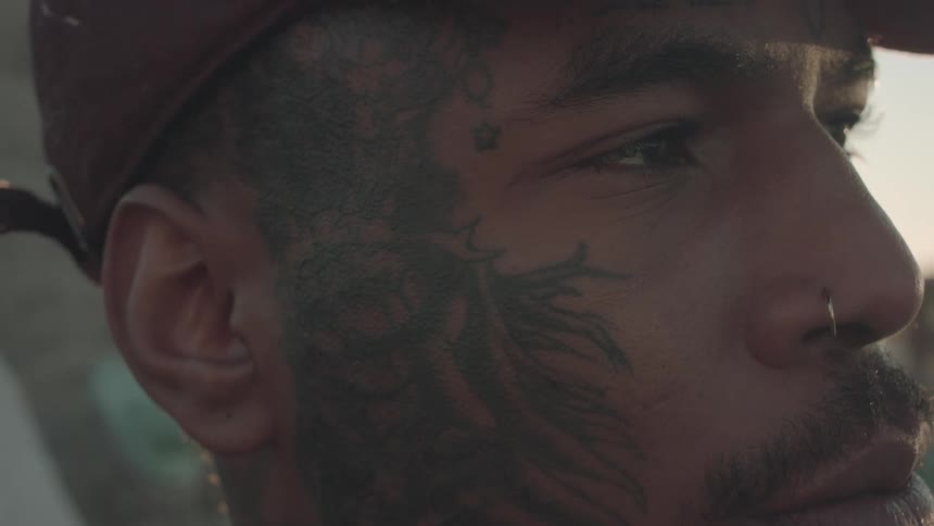 Side portrait of a tattooed man