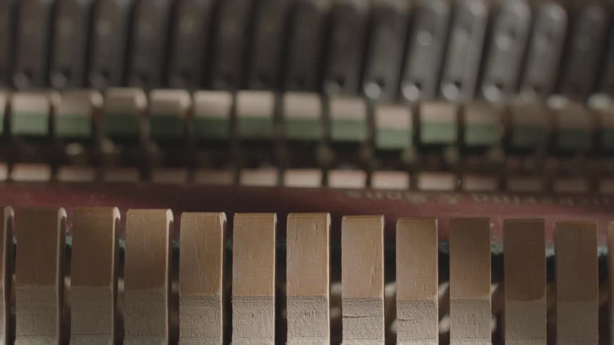 Internal components of a piano move as the musical instrument is played