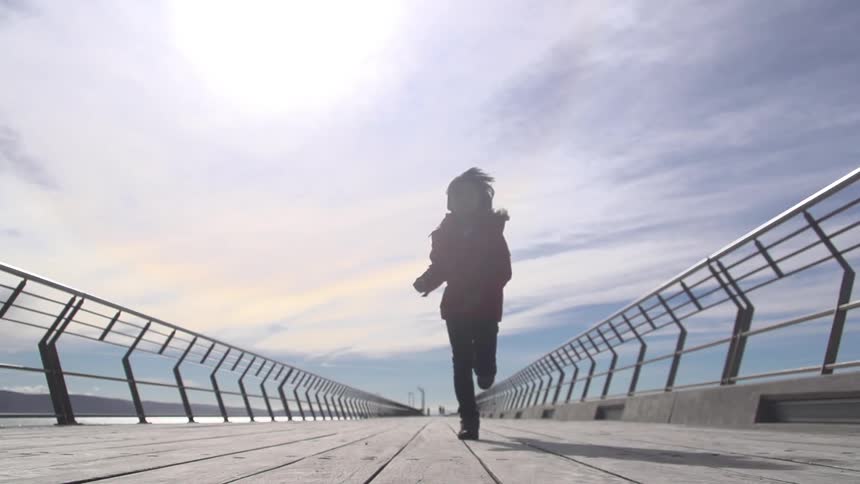 A person running down the pier