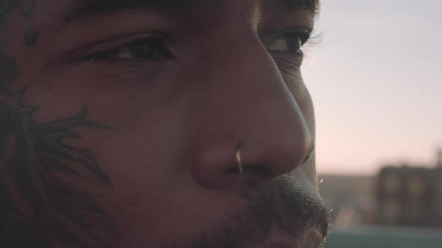 Portrait of a man with a tattooed face