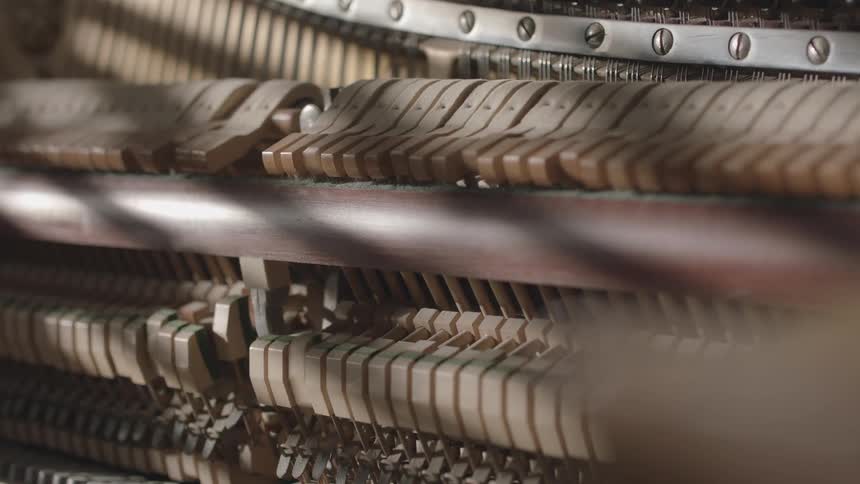 Closeup of a pianos internal mechanism as it plays automatically