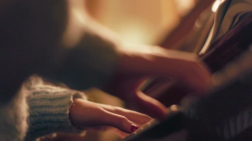 Pair of hands of a woman playing the piano