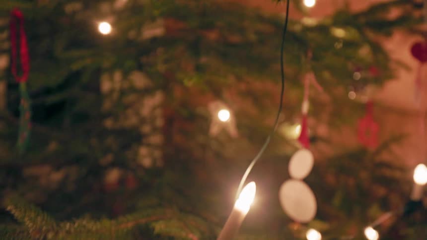 A christmas tree is set up with lights and ornaments