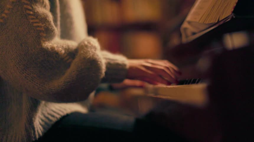 Person sitting playing piano