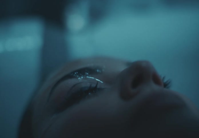 Water from a tap running down a womans face