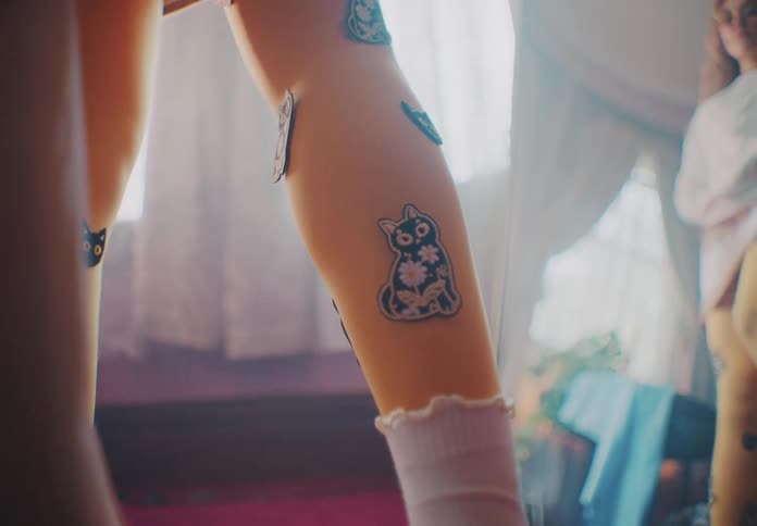 Legs of a young woman with stickers glued on them