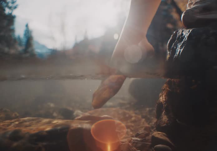 Womans foot entering a stream