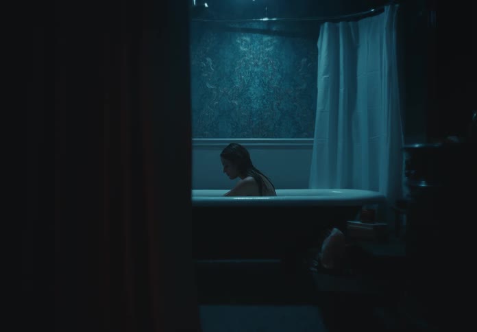 A woman is bathing in the bathtub