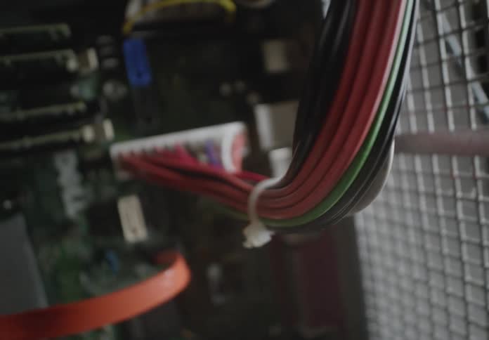 Closeup view of a computer motherboard with various connected cables and components inside a pc case