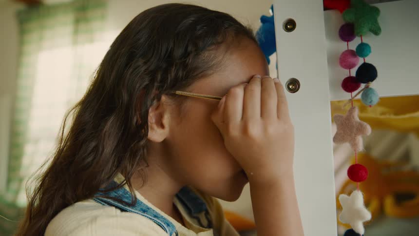 A girl counts while playing hide and seek