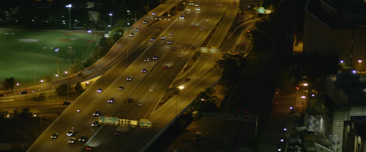 The highway below has many roads full of cars