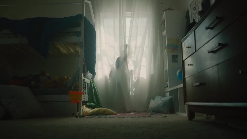 Two children playing behind a curtain