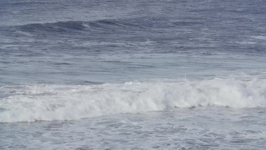 Waves crashing against the beach