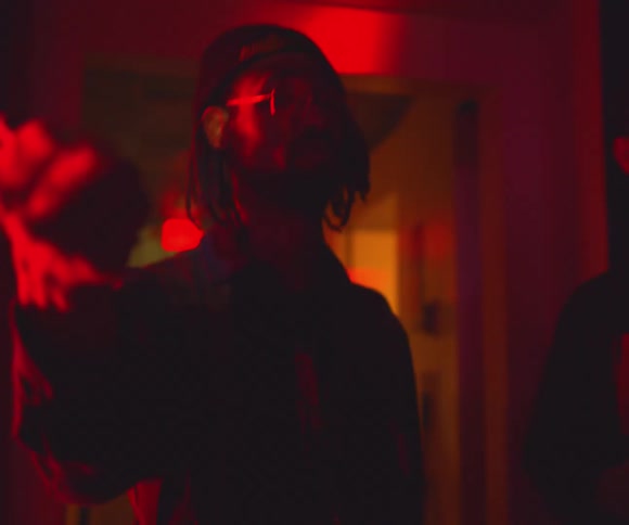 A man at a party dancing with neon lights