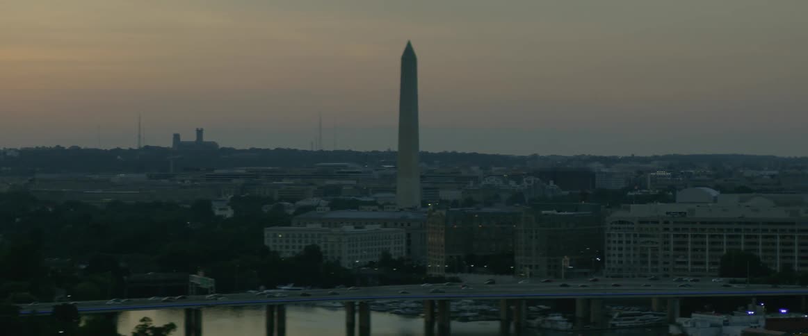 A bridge crosses a river into a large city