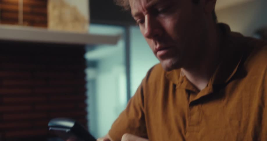 Man sitting typing on a calculator