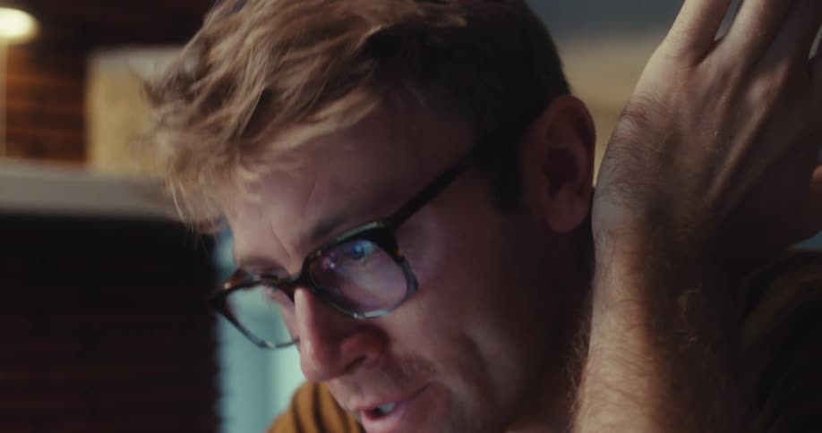 Man talking and taking off his glasses